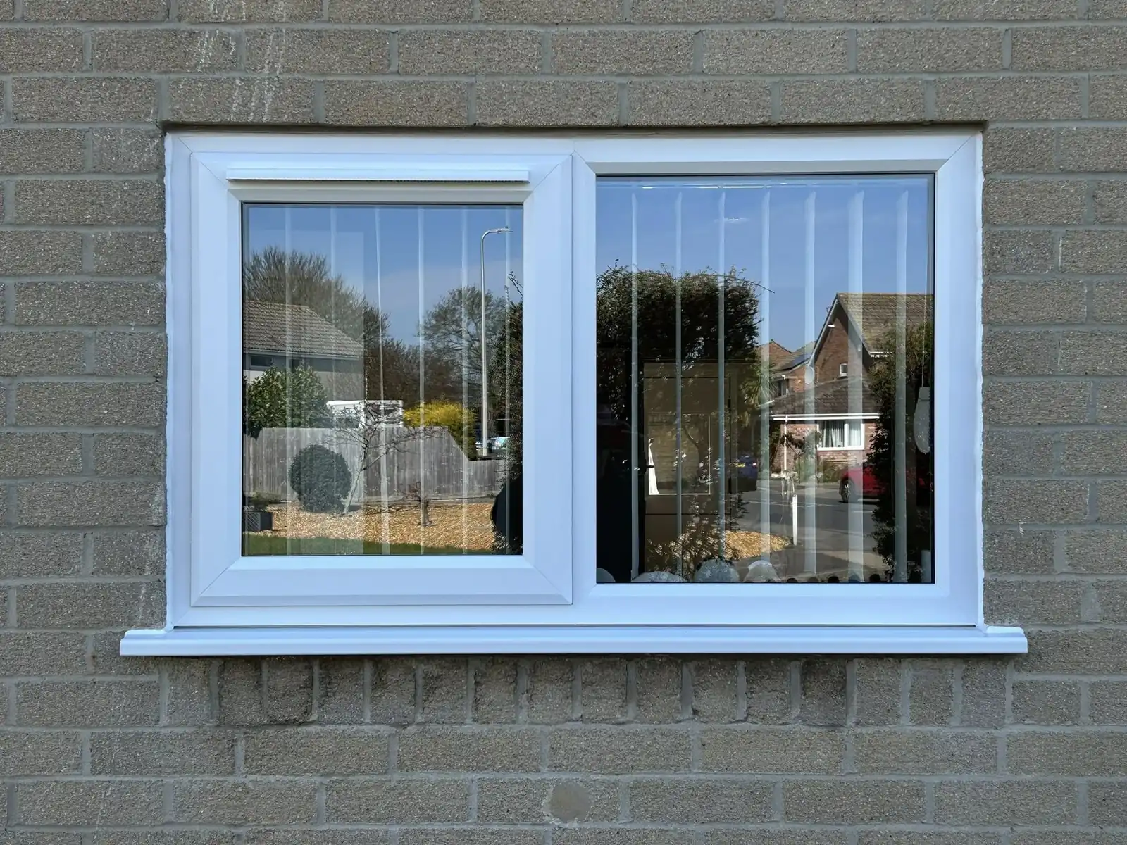 White two-pane window viewed from the garden