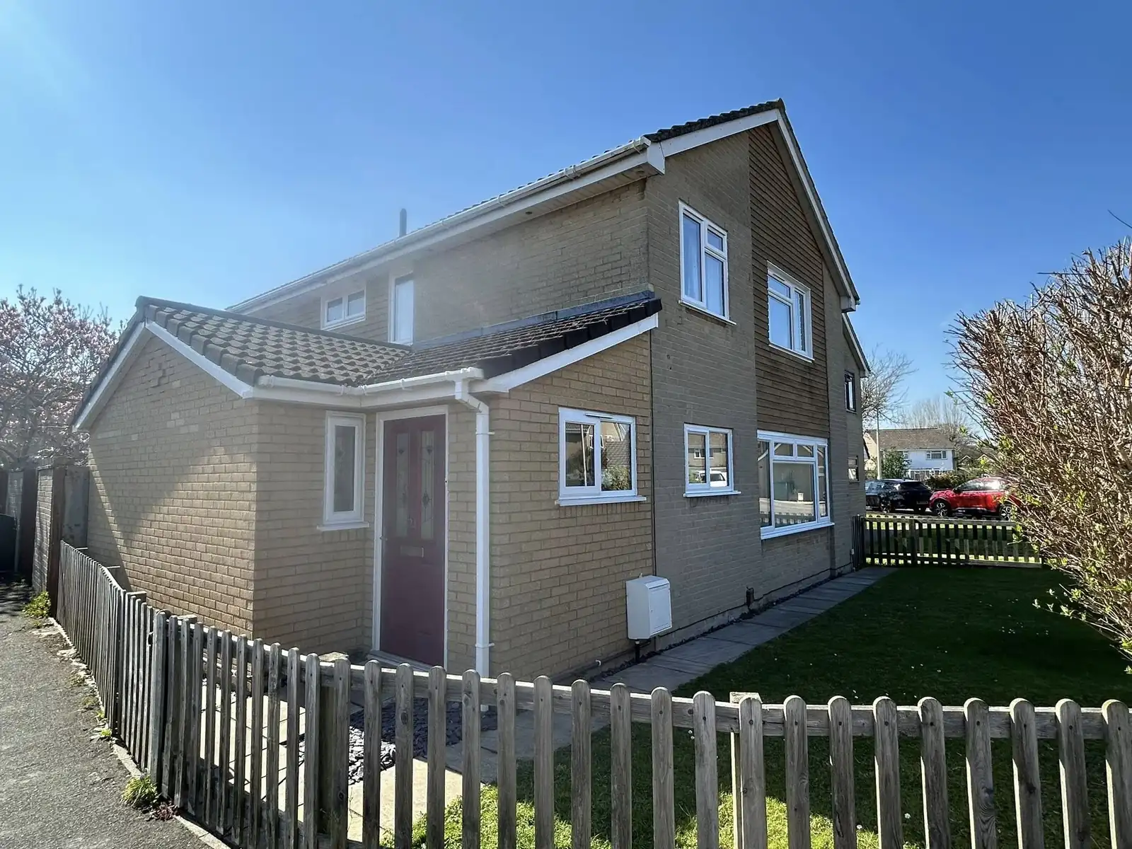 White windows and entrance door on a detached house