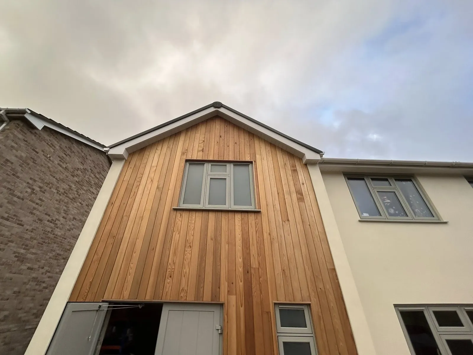 Front elevation with timber cladding and replacement windows