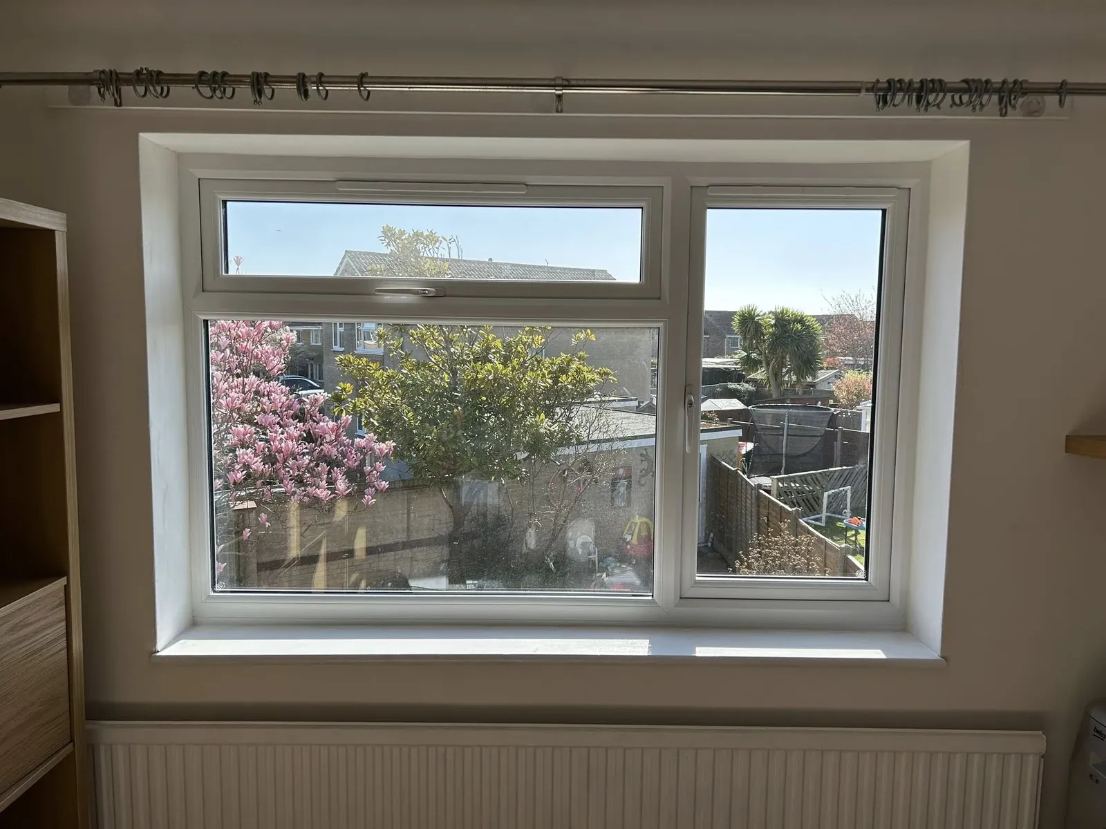 White window with a view of a planted garden
