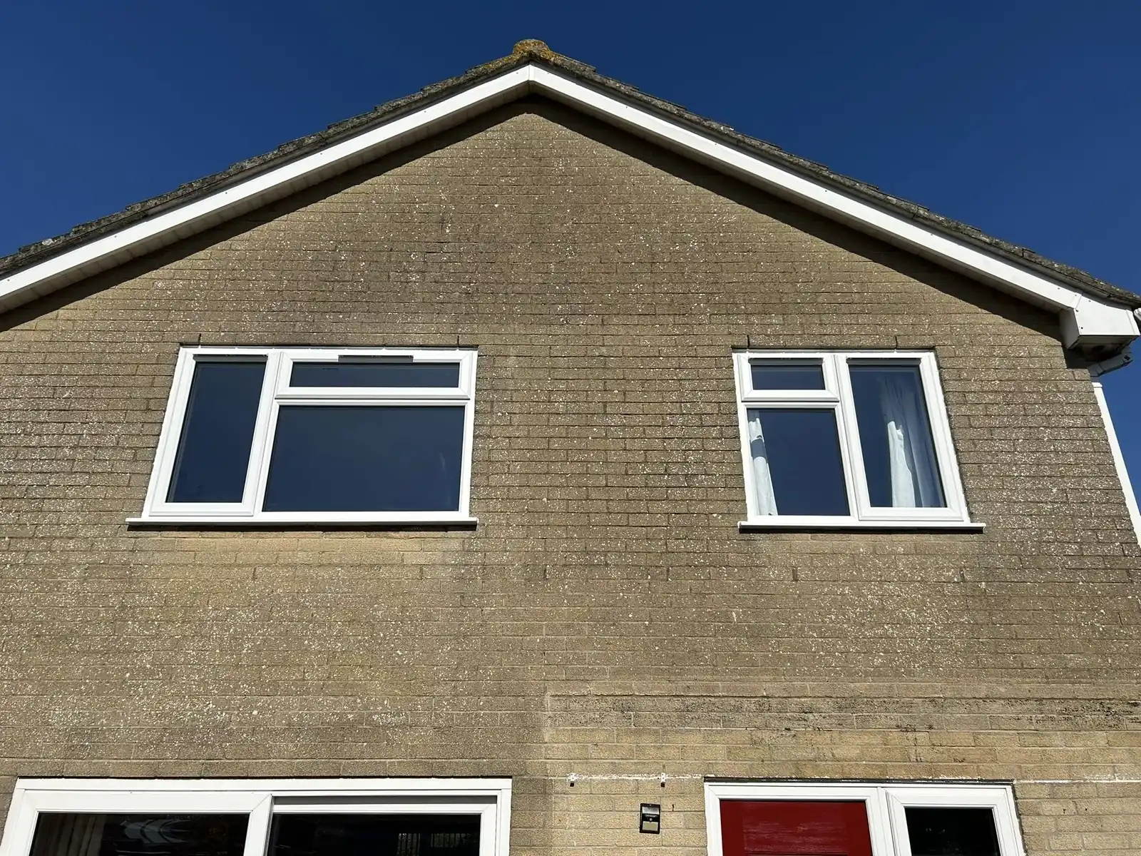White upper-storey windows beneath a gabled roof