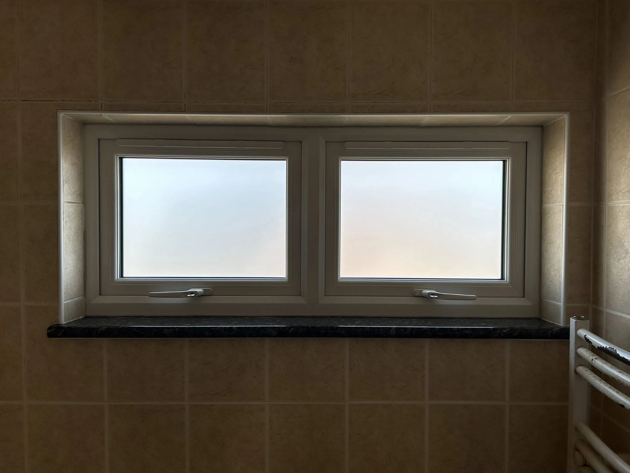 White two-pane bathroom window with privacy glazing