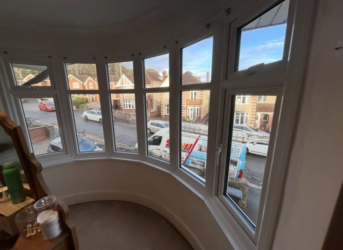 Curved white bay window seen from indoors